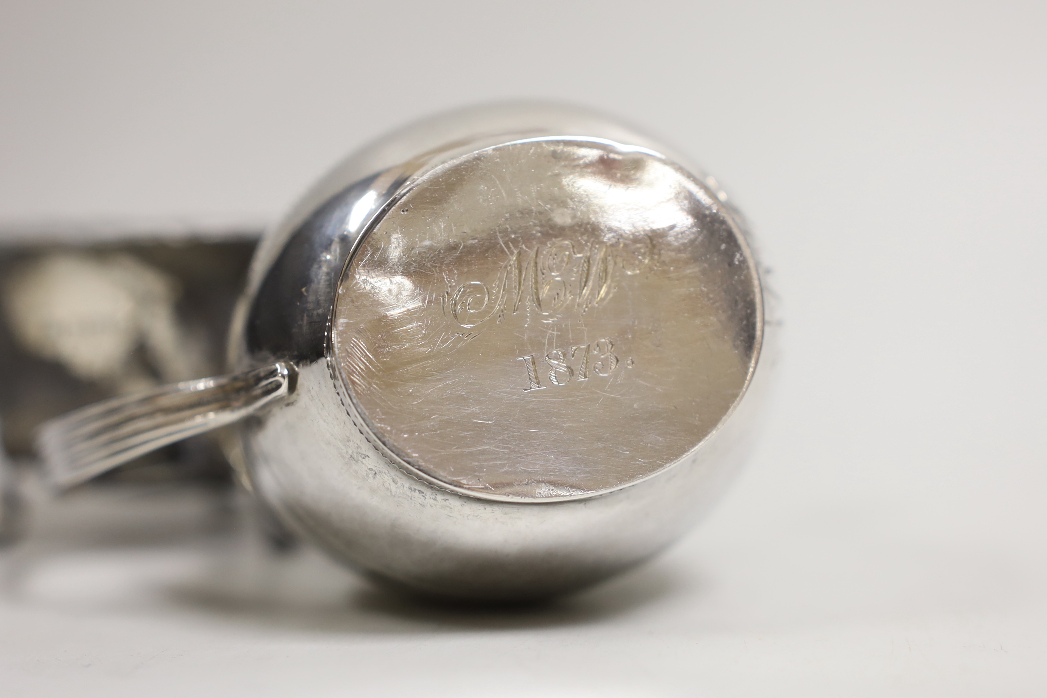 A George III chased silver cream jug, James Mince, London, 1809, 81mm and a later silver sugar bowl, 4.4oz.